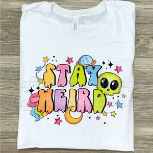 Stay Weird alien Graphic T-Shirt with spaceship and stars